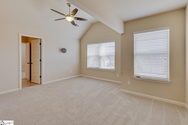 spare room featuring ceiling fan, vaulted ceiling, and light carpet