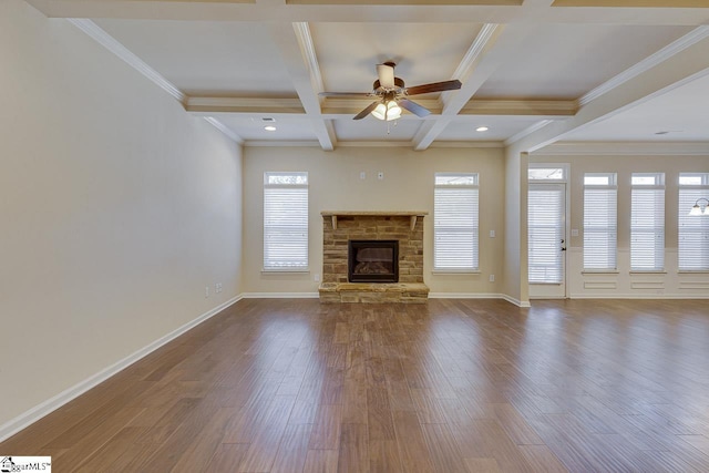 unfurnished living room with coffered ceiling, ornamental molding, dark hardwood / wood-style floors, a fireplace, and beam ceiling