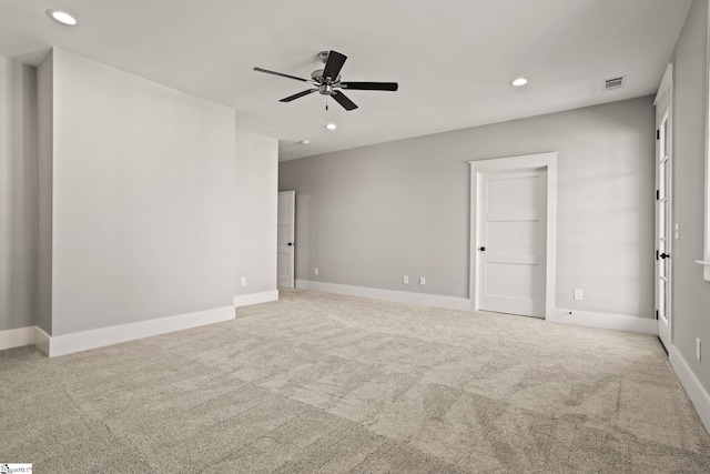 carpeted spare room with ceiling fan