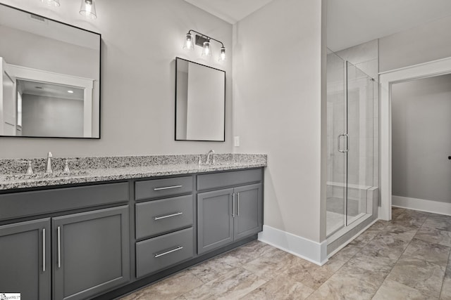 bathroom with a shower with door and vanity