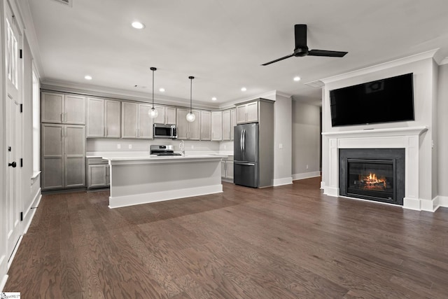 kitchen featuring a center island, ceiling fan, gray cabinets, pendant lighting, and appliances with stainless steel finishes