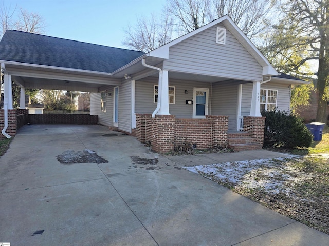 view of front of home featuring covered porch and a carport