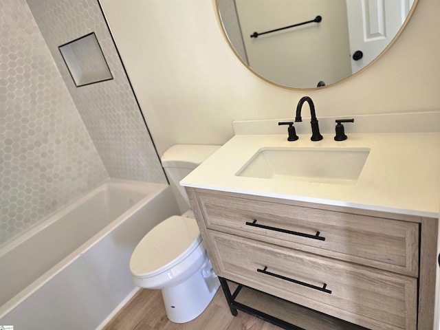 full bathroom with toilet, hardwood / wood-style flooring, shower / washtub combination, and vanity