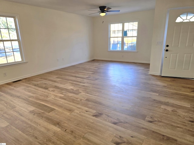 entrance foyer featuring light wood-type flooring, ceiling fan, and a wealth of natural light