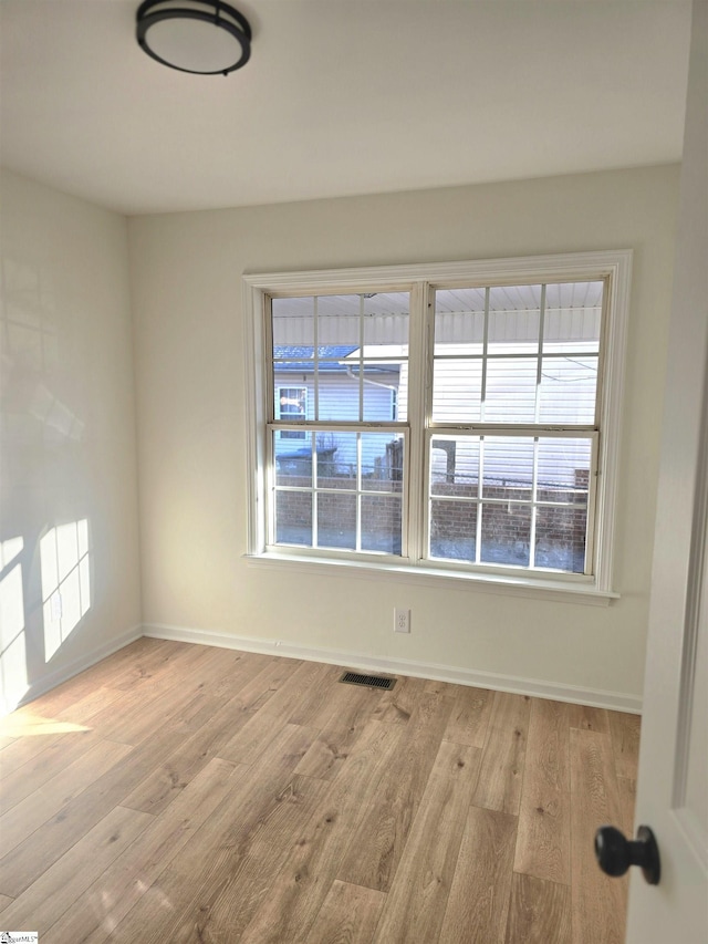 spare room featuring light hardwood / wood-style flooring