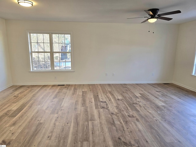 empty room featuring ceiling fan and light hardwood / wood-style flooring