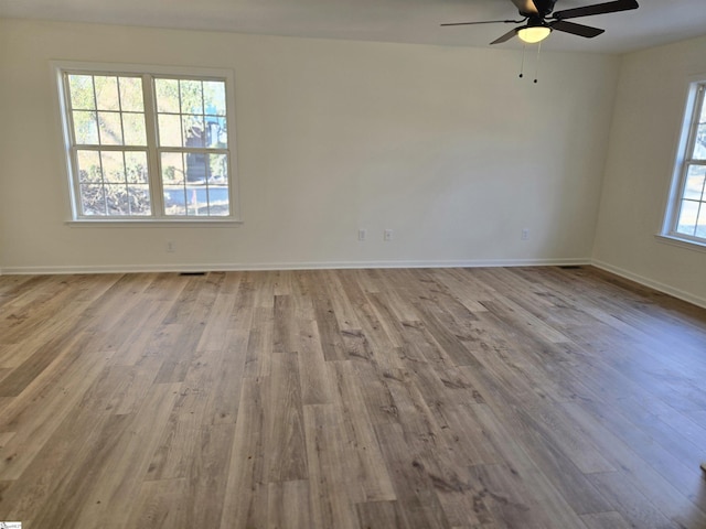 empty room featuring ceiling fan and light wood-type flooring