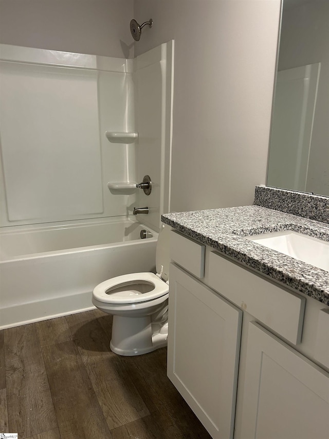 full bathroom with toilet, vanity, hardwood / wood-style floors, and tub / shower combination