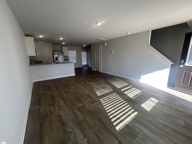 unfurnished living room with dark hardwood / wood-style floors