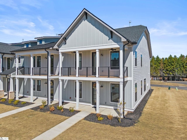 view of front facade with a balcony and a front yard