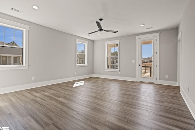 empty room with ceiling fan and dark hardwood / wood-style floors