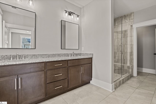 bathroom featuring an enclosed shower, vanity, and tile patterned floors