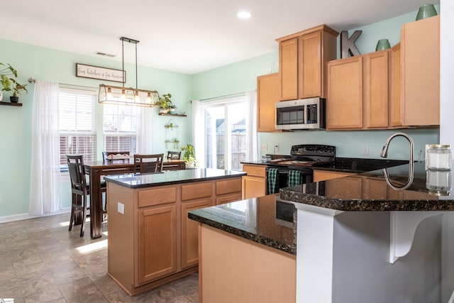 kitchen featuring a center island, decorative light fixtures, black electric range oven, dark stone countertops, and sink