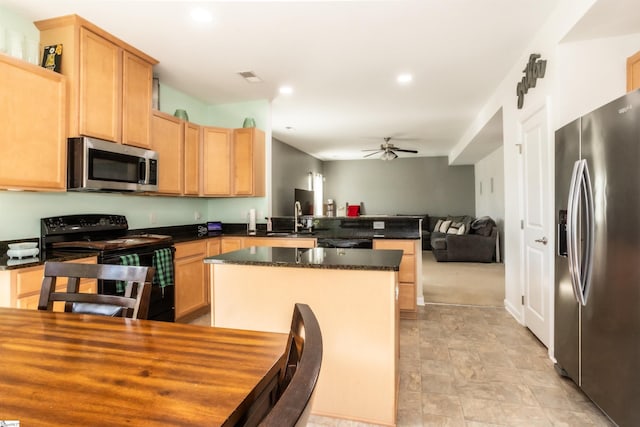 kitchen with a center island, light brown cabinetry, black appliances, ceiling fan, and sink