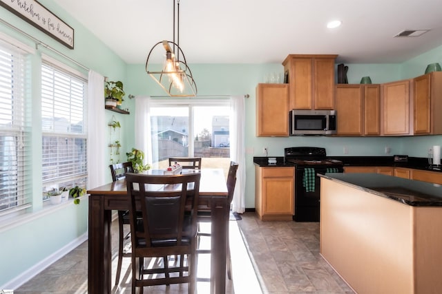 kitchen featuring decorative light fixtures, a notable chandelier, and black electric range oven