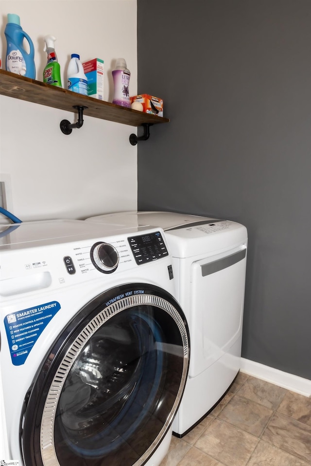 washroom featuring washer and clothes dryer