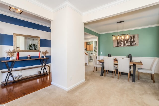 carpeted dining area featuring a notable chandelier and crown molding