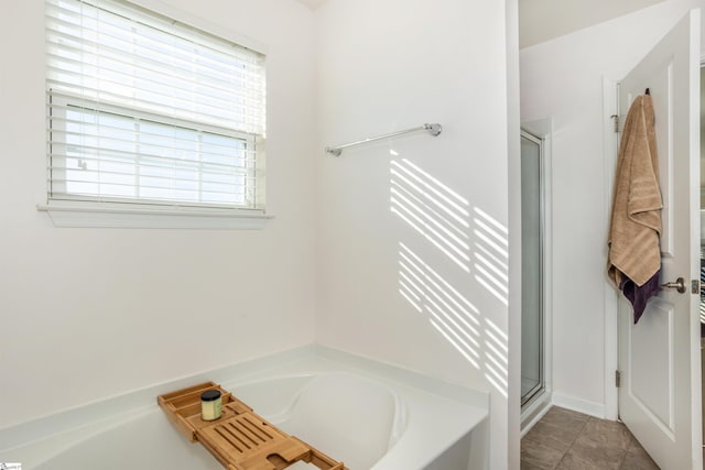 bathroom featuring tile patterned flooring, a healthy amount of sunlight, and plus walk in shower