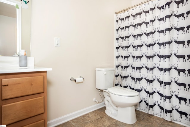 bathroom featuring toilet and vanity