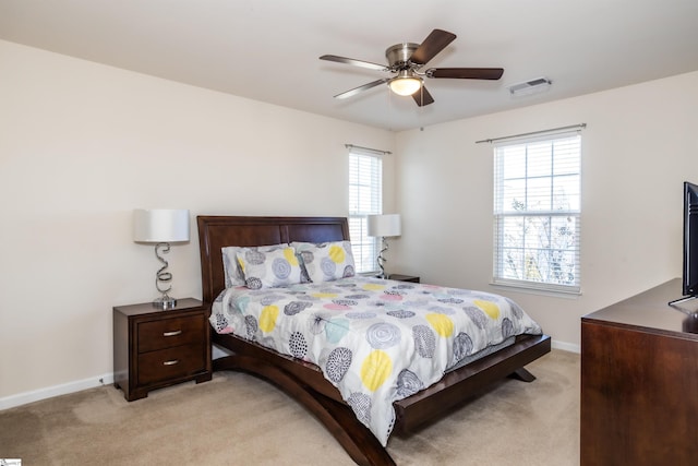 bedroom with ceiling fan and light carpet