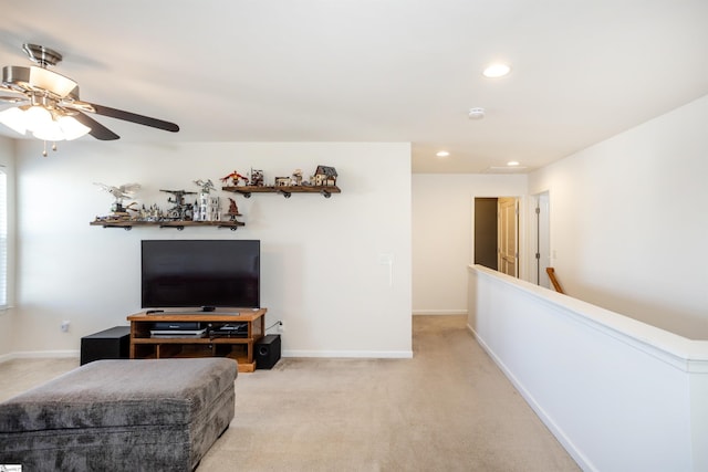 carpeted living room with ceiling fan