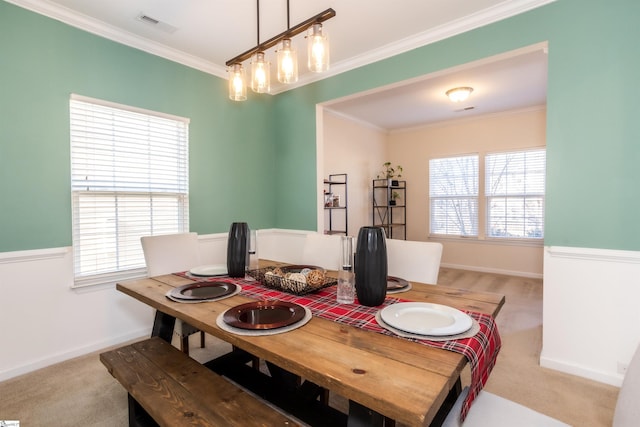 carpeted dining area featuring crown molding