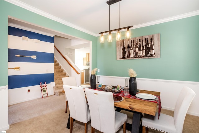 dining room featuring carpet floors and ornamental molding