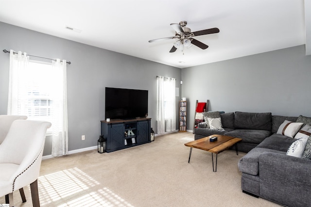 carpeted living room with ceiling fan and a healthy amount of sunlight