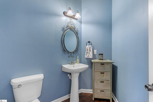 bathroom with sink, hardwood / wood-style flooring, and toilet