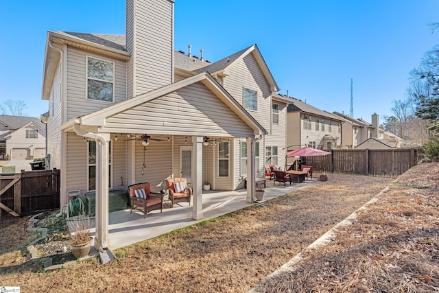 rear view of house featuring a patio area and ceiling fan