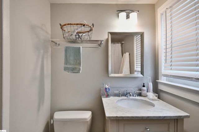 bathroom featuring toilet and vanity