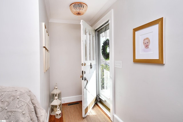 foyer featuring ornamental molding and hardwood / wood-style floors