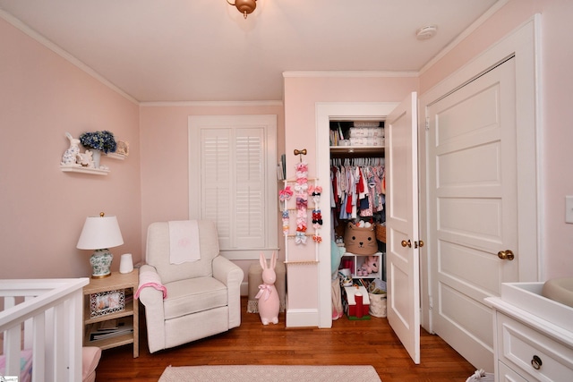 bedroom with ornamental molding, dark wood-type flooring, and a closet