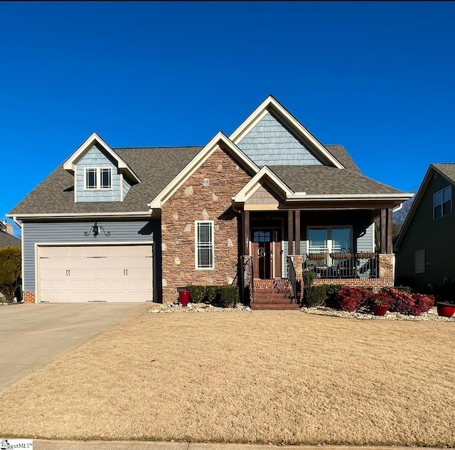 craftsman house with a porch and a garage