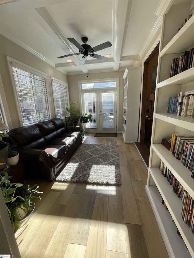 living room featuring french doors, crown molding, and a wealth of natural light