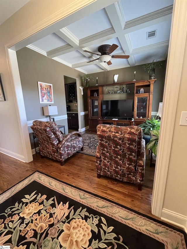 living room featuring coffered ceiling, hardwood / wood-style flooring, crown molding, ceiling fan, and beamed ceiling