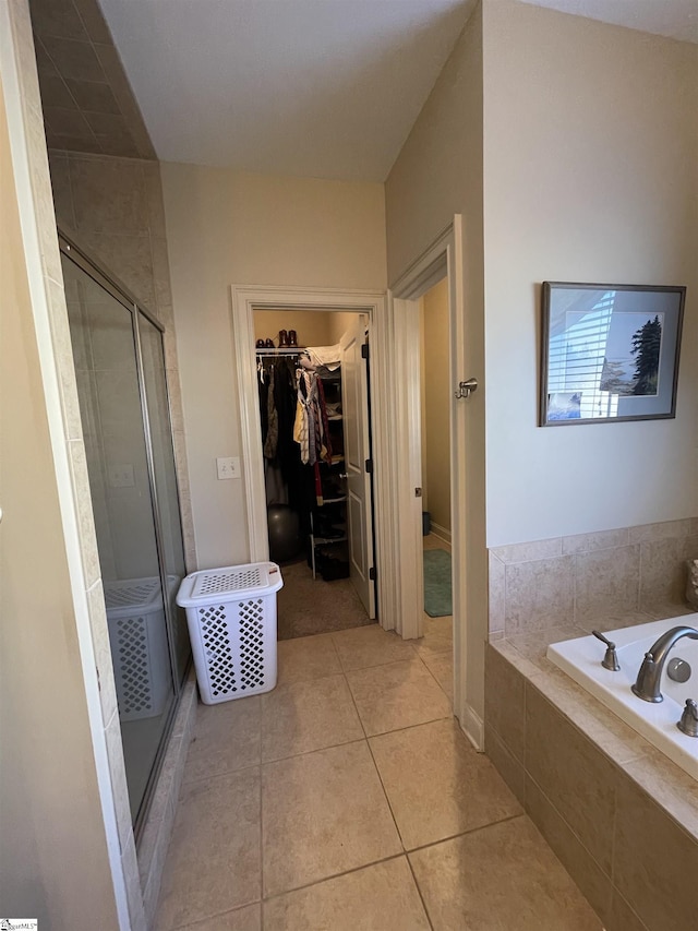 bathroom featuring tile patterned flooring and separate shower and tub