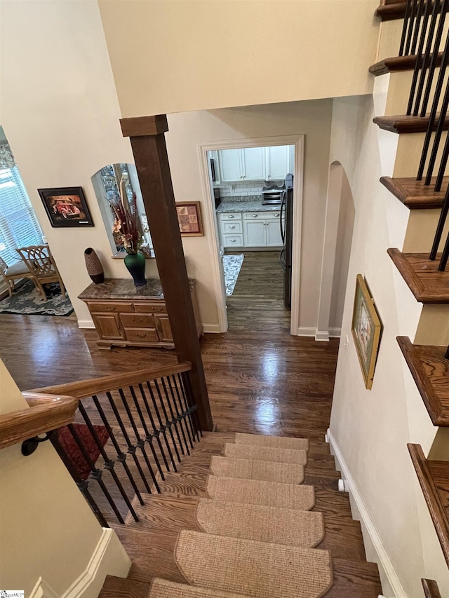 staircase with wood-type flooring