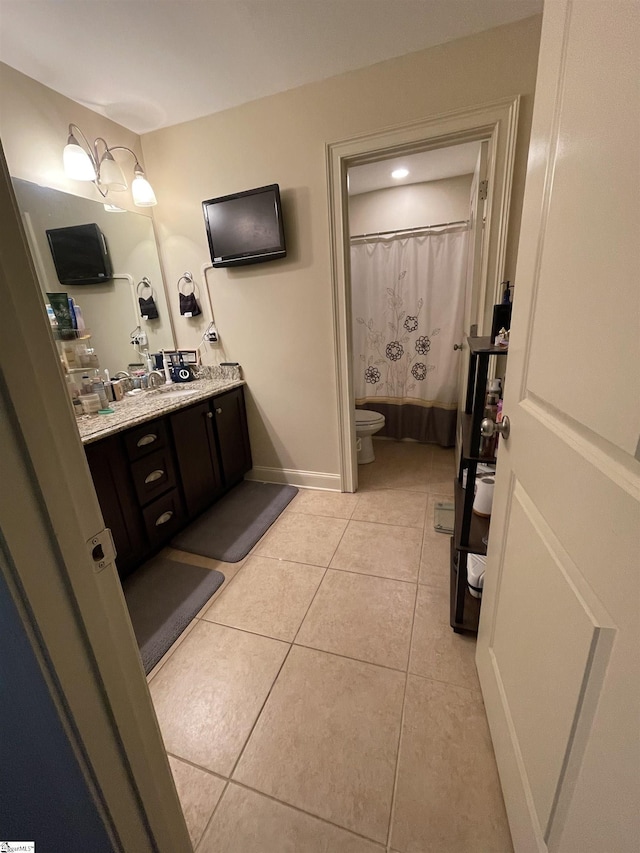 bathroom with toilet, a shower with curtain, tile patterned floors, and vanity