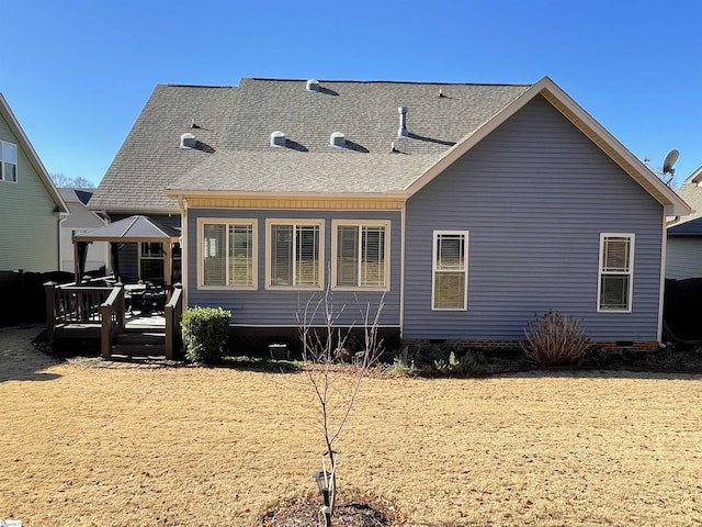 rear view of house with a deck and a gazebo