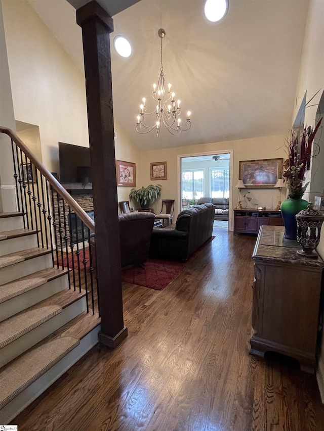 interior space featuring high vaulted ceiling, an inviting chandelier, and dark hardwood / wood-style flooring