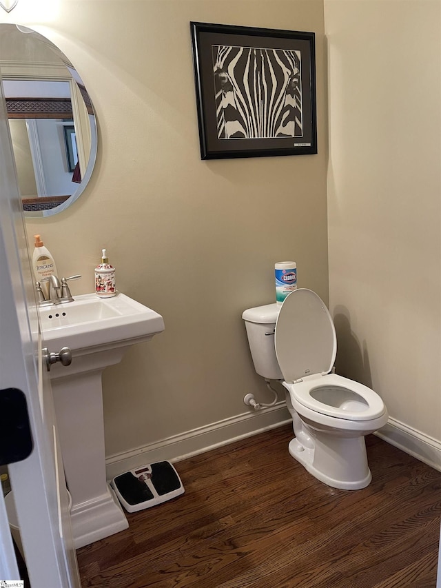 bathroom with toilet and wood-type flooring