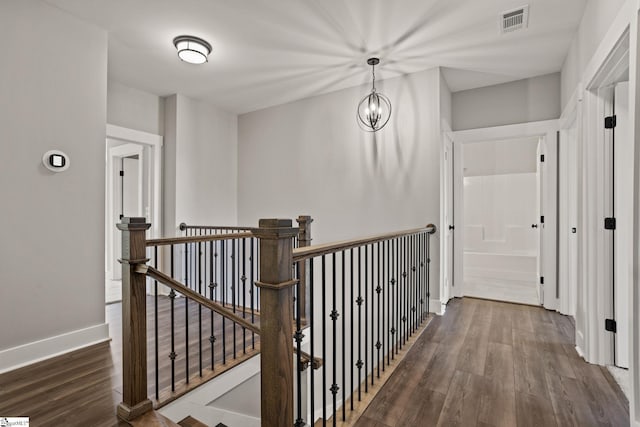 hall featuring dark hardwood / wood-style flooring and a notable chandelier