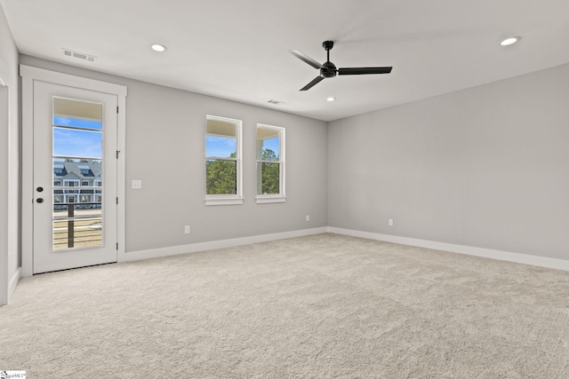 carpeted empty room featuring ceiling fan