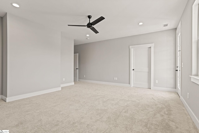 carpeted spare room featuring ceiling fan