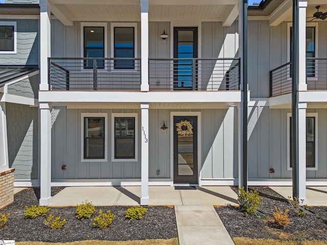 view of exterior entry featuring a balcony