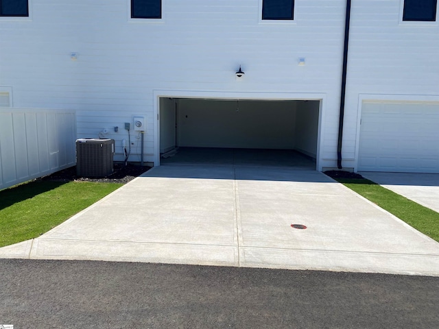 view of property exterior featuring central AC unit and a garage