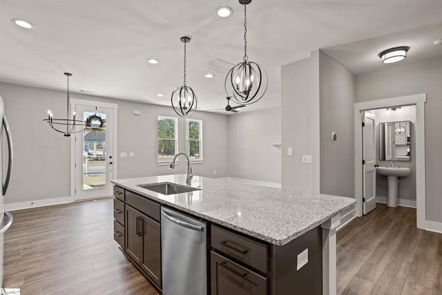 kitchen featuring light stone countertops, stainless steel dishwasher, sink, a center island with sink, and dark brown cabinetry