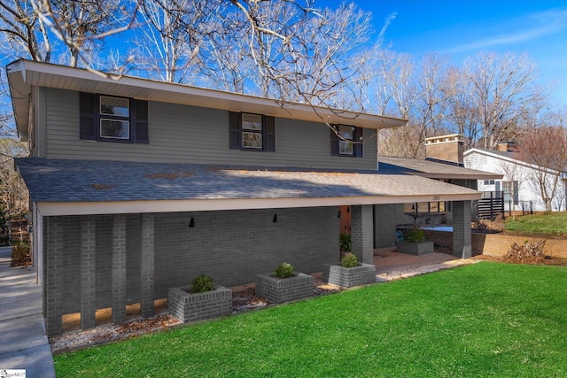 rear view of property featuring a patio area and a lawn