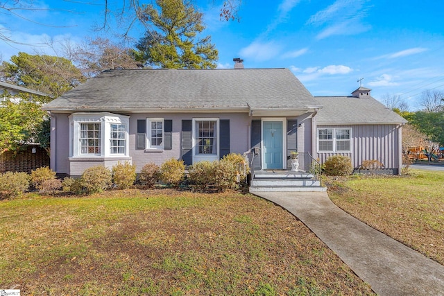 bungalow-style house featuring a front yard